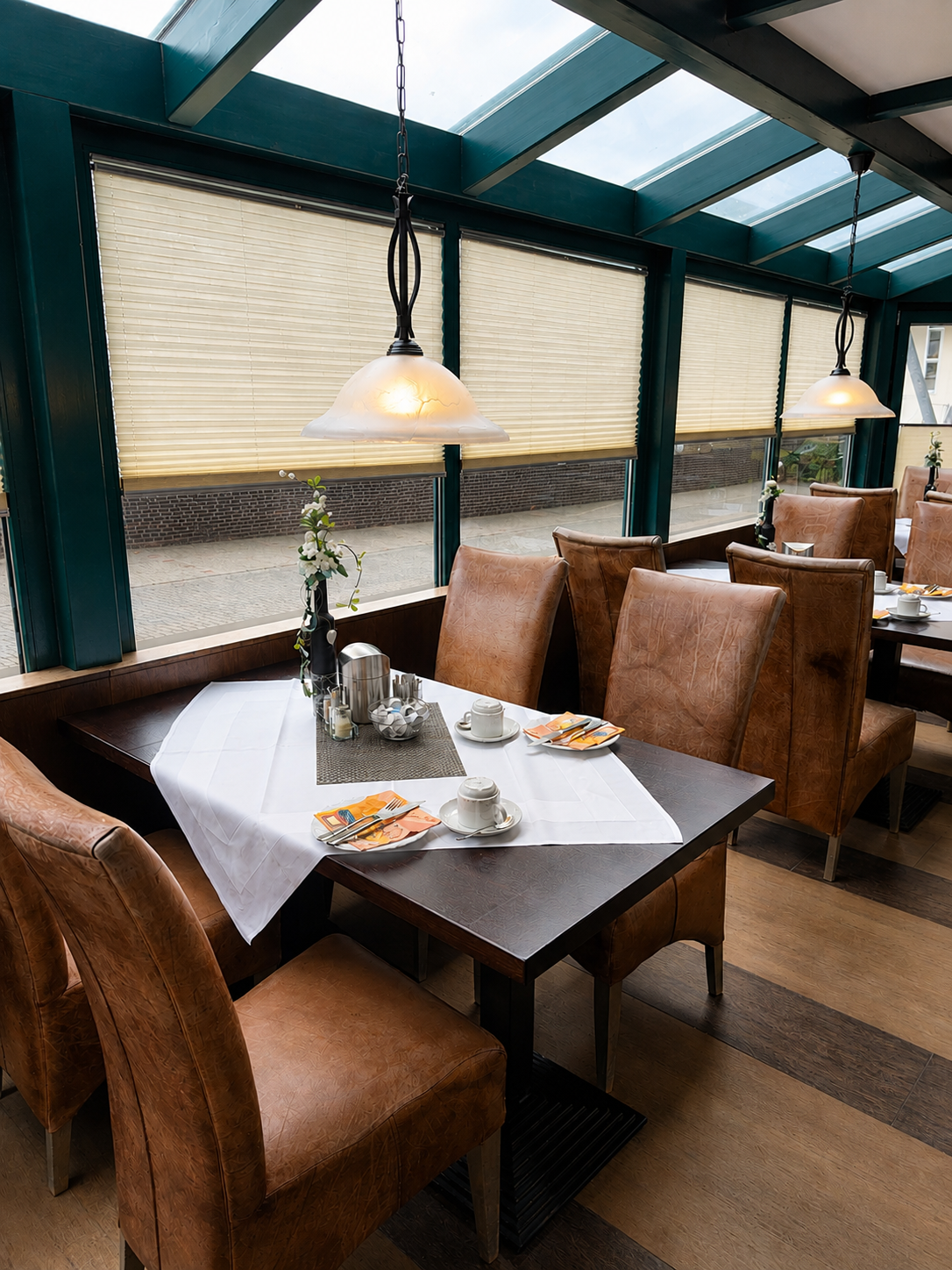 Bright and welcoming breakfast room with comfortable seating at City Hotel Friesoythe  Titel